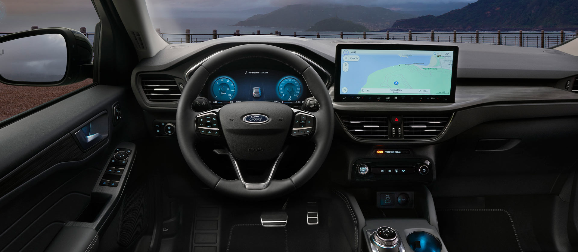 Itselataavan Ford Kuga täyshybridi-auton sisätilat ja navigointinäyttö.