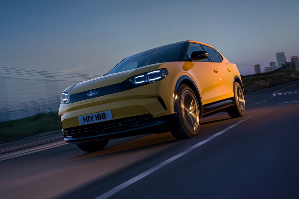 Keltainen Ford Capri -täyssähköauto ajaa maantiellä.