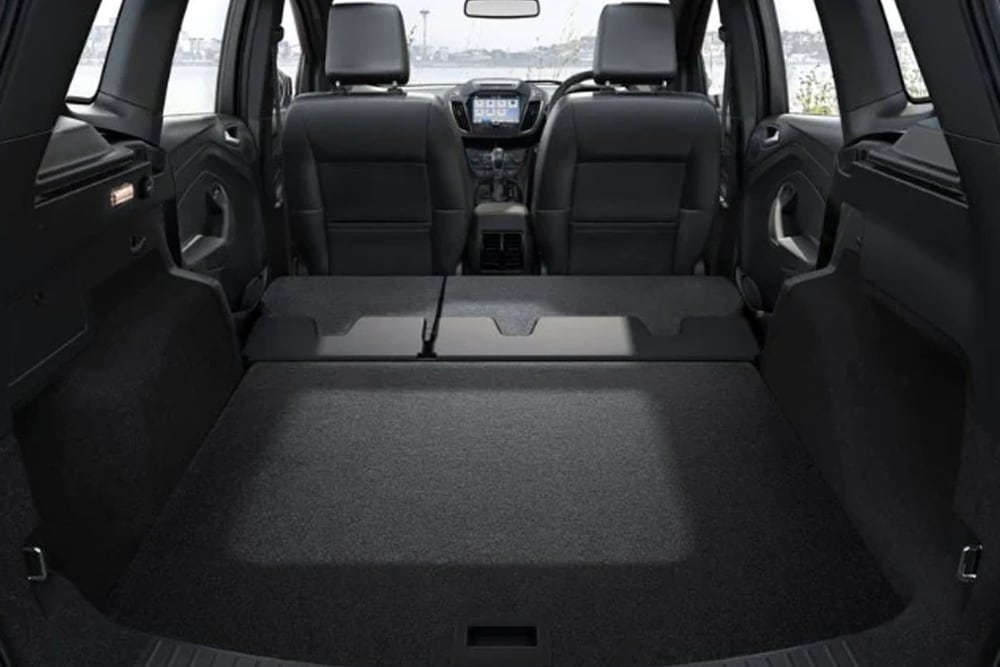 The empty trunk space of a Ford vehicle.
