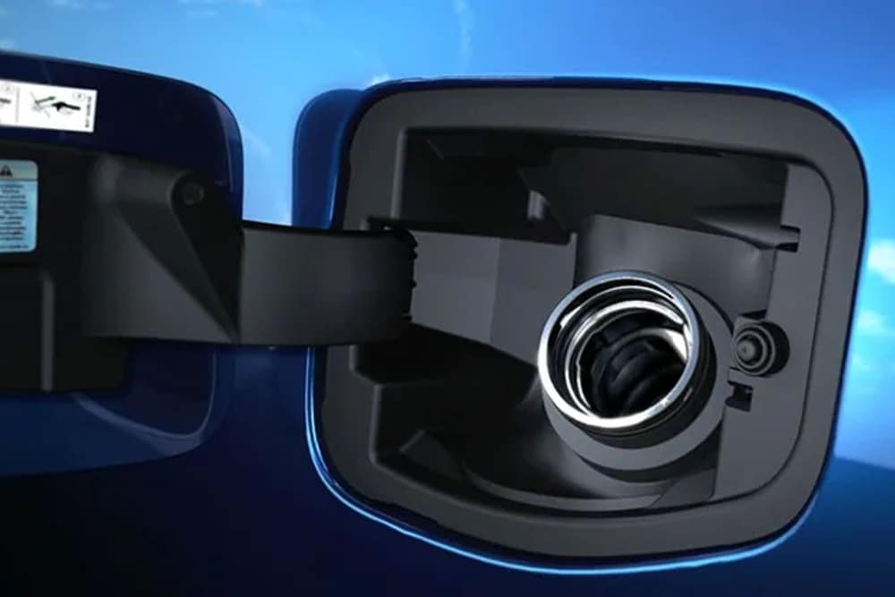 Close up of the Fuel filler on a blue Ford vehicle with fuel cap open.