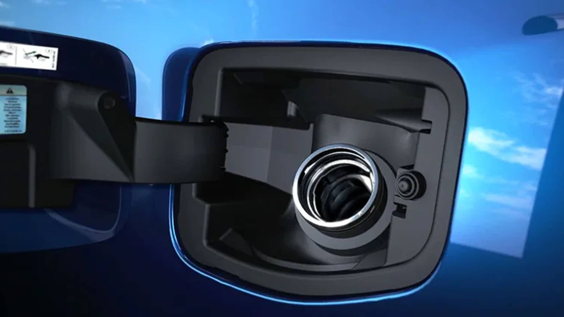 Close up of the Fuel filler on a blue Ford vehicle with fuel cap open.