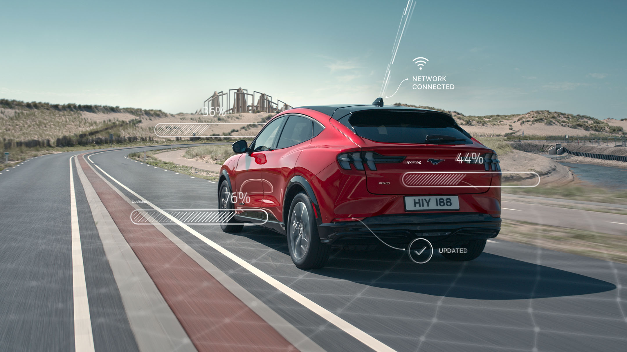 Rear view of a red Ford Mustang Mach-e driving along a road with connectivity diagrams coming off the vehicle