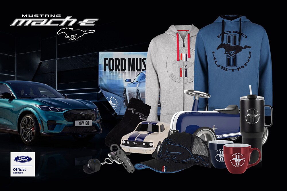 Ford merchandise collection featuring various Ford vehicles in the background with Ford branded umbrella, mugs, and clothing items.