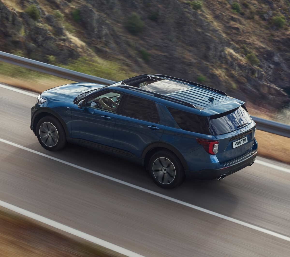 Ford Explorer driving on mountain road birds-eye view