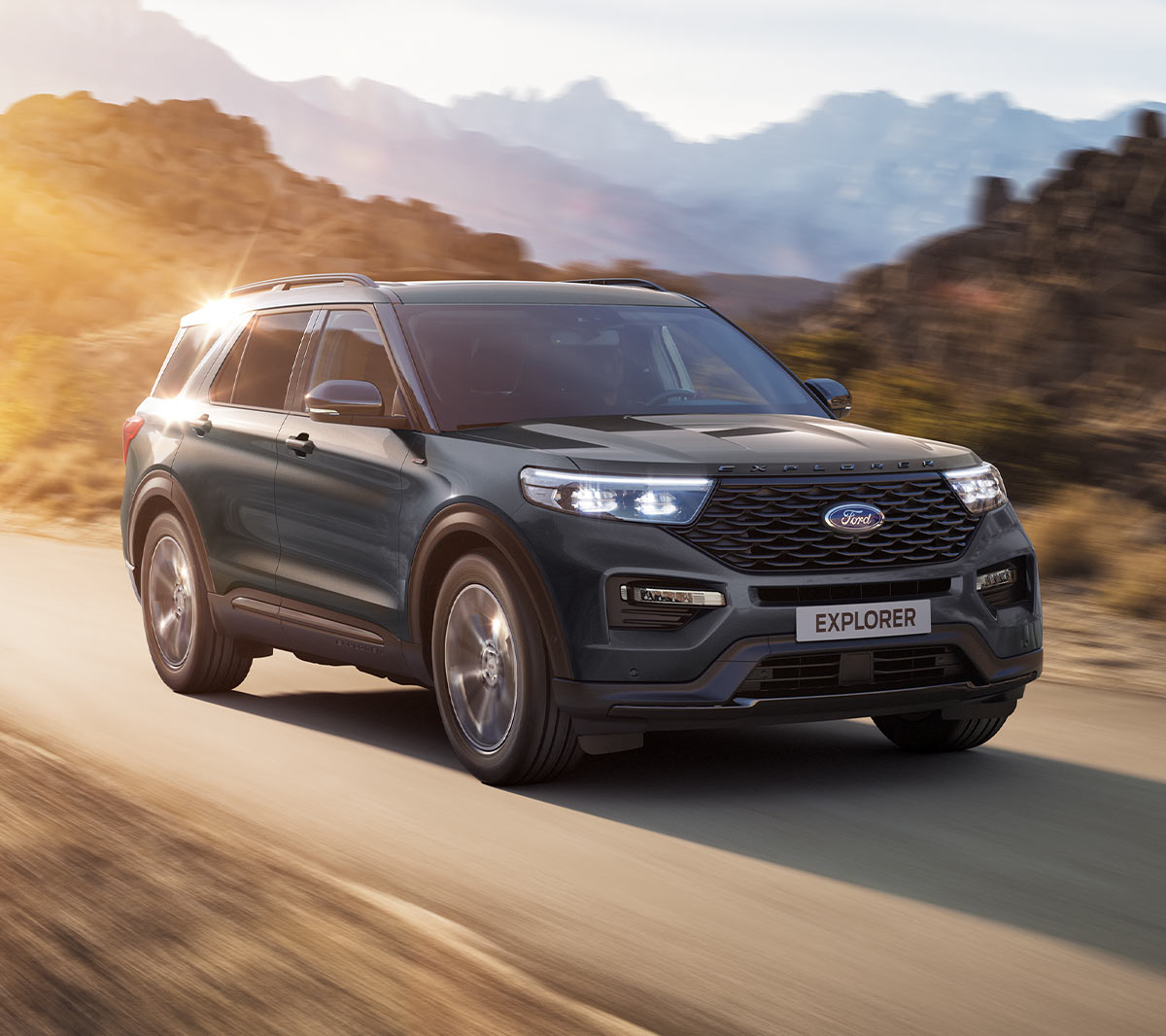 Ford Explorer in motion driving in sun drenched road