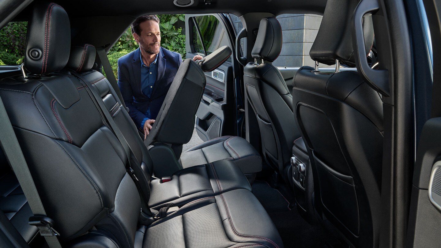 Ford Explorer interior with a person folding back seat