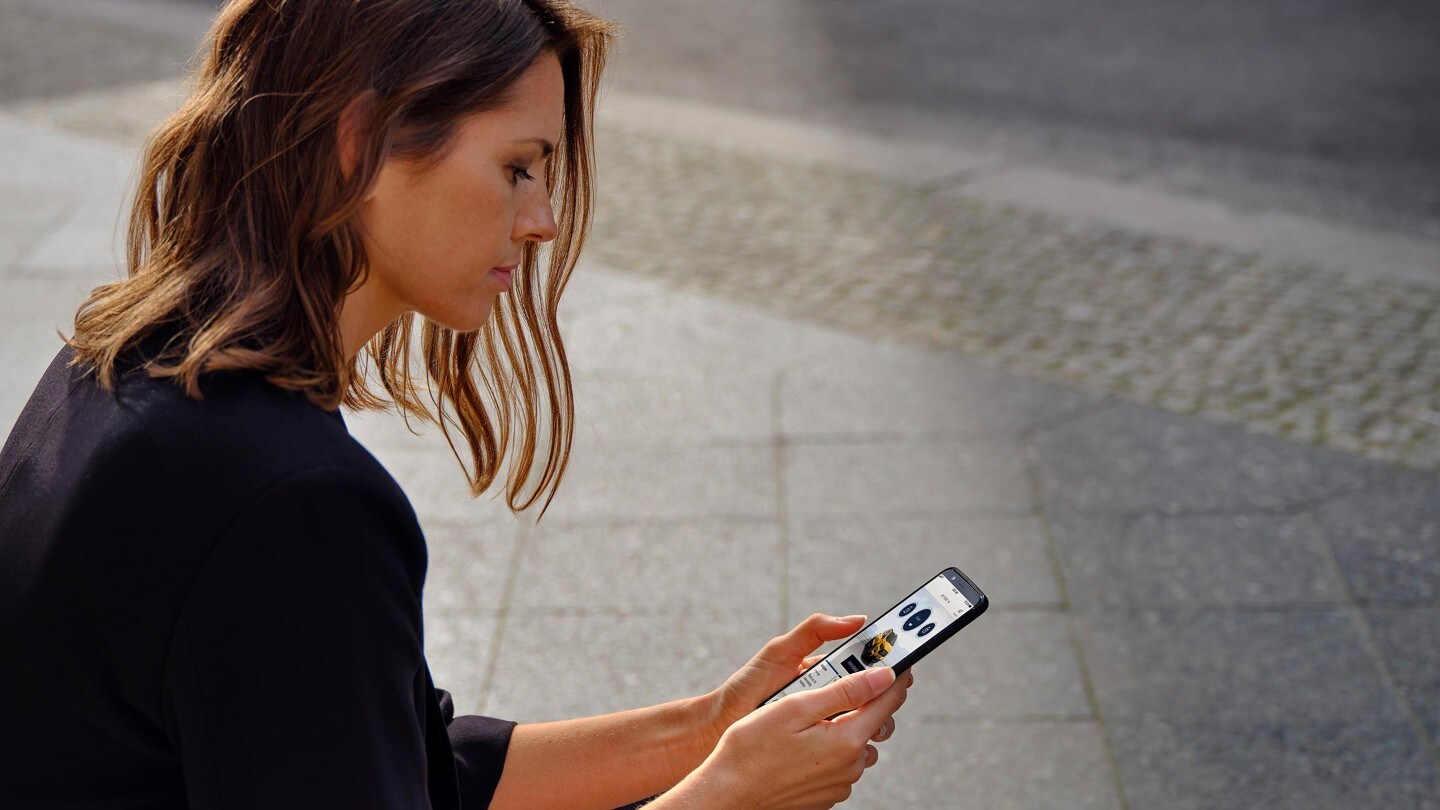 Woman looking at phone sitting down