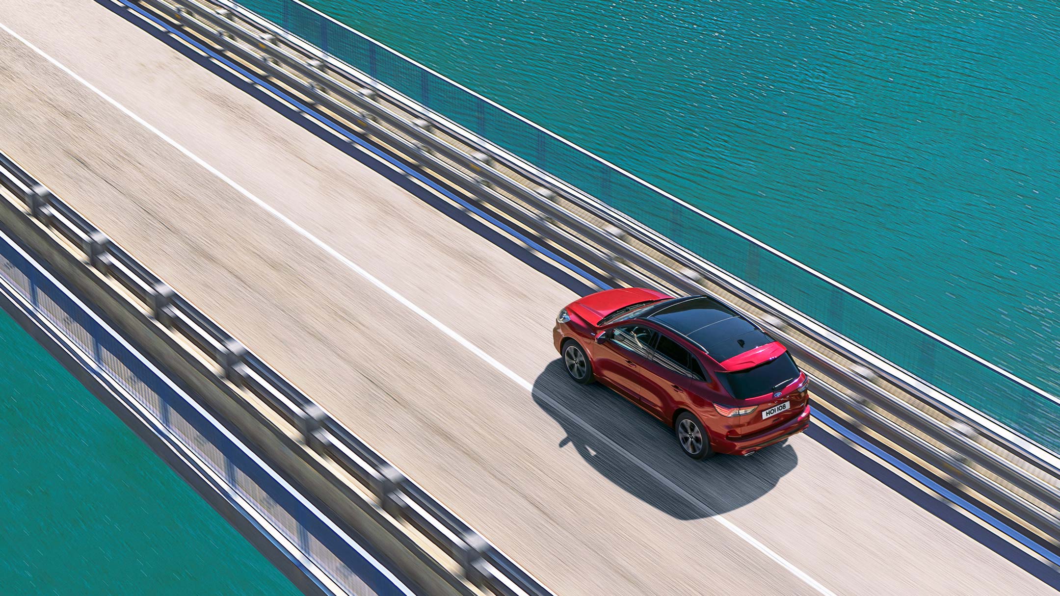 All New Red Ford Kuga driving on bridge above water