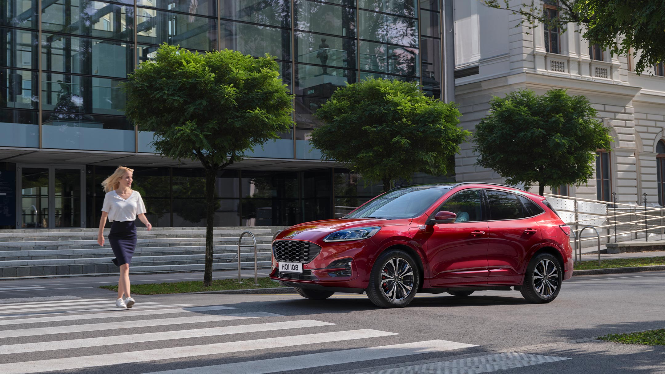 All new Red Kuga with woman crossing road