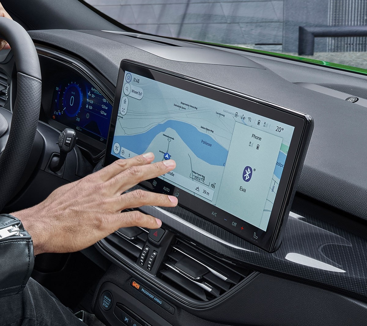 Hand interacting with a touchscreen on a dashboard
