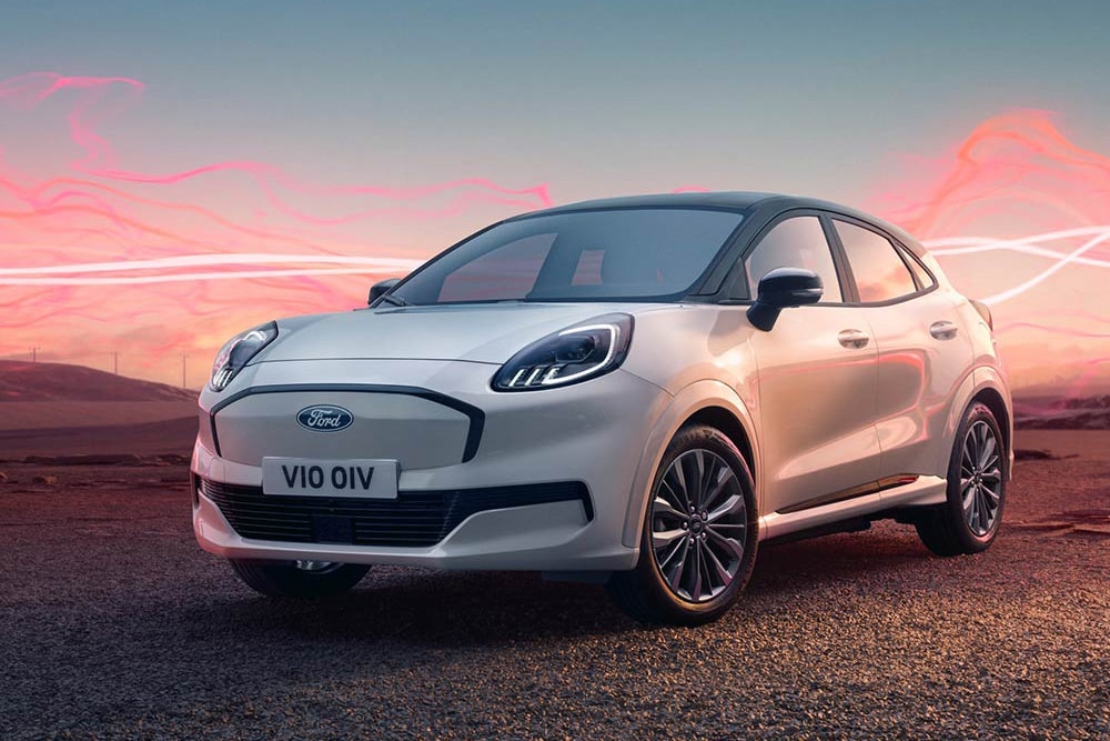 Valkoinen Ford Puma Gen-E Sound Edition -malli pysäköitynä, taustalla punaiset ääniaaltografiikat.