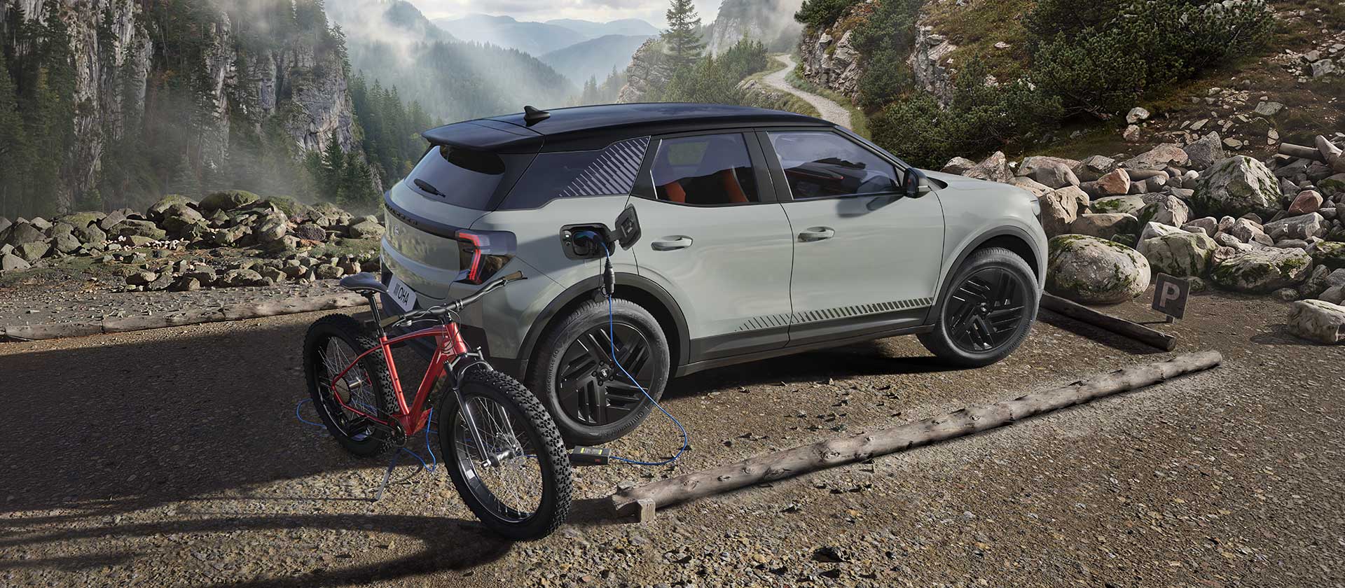 Sähköpyörä latautuu Ford Explorerin® avulla. Vuorimaisema taustalla.