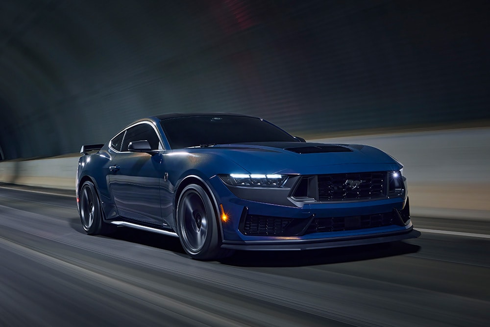 Vapour blue -värinen Ford Mustang -urheiluauto ajamassa tunnelissa.