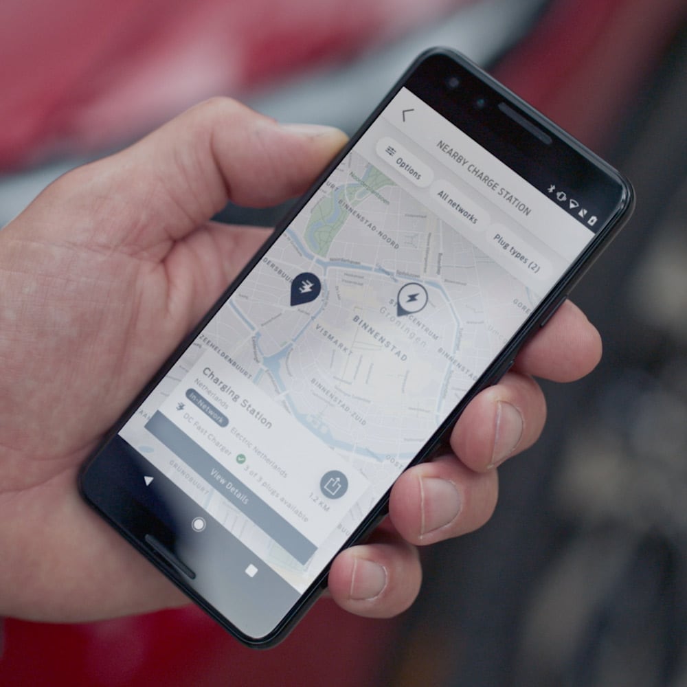 Henkilö käyttää FordPass-sovellusta älypuhelimellaan