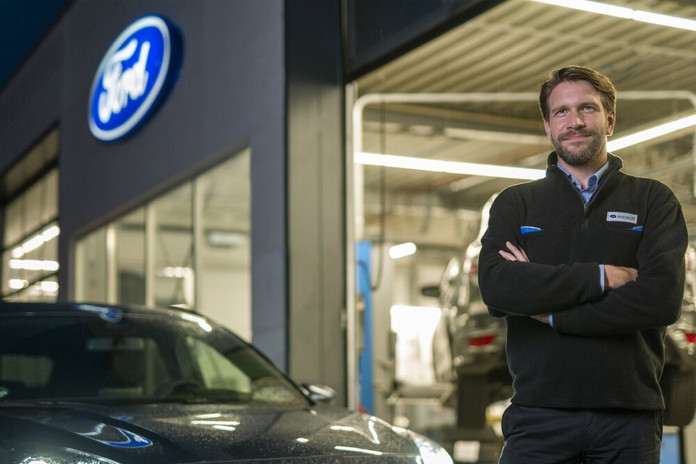 Smiling Ford Service customer in Grey Ford