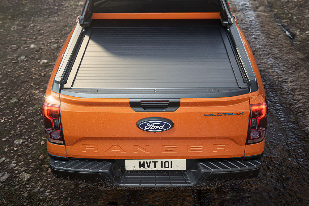 Ylhäältäpäin kuvattu oranssin Ford Rangerin kuormalava ja lavapeite.